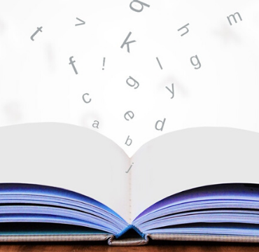An open book with computerised letters emerging from it