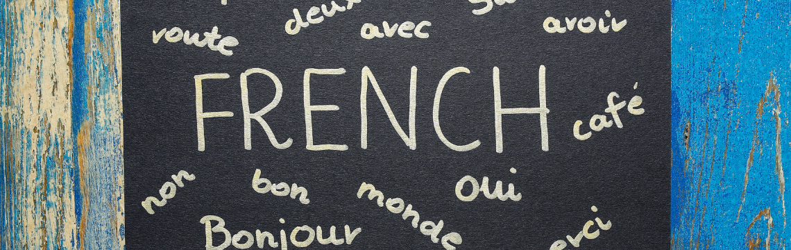 Black chalkboard with different commonly used French words