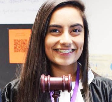 Headshot of Business & Law student holding a gavel