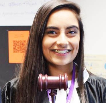 Headshot of Business & Law student holding a gavel