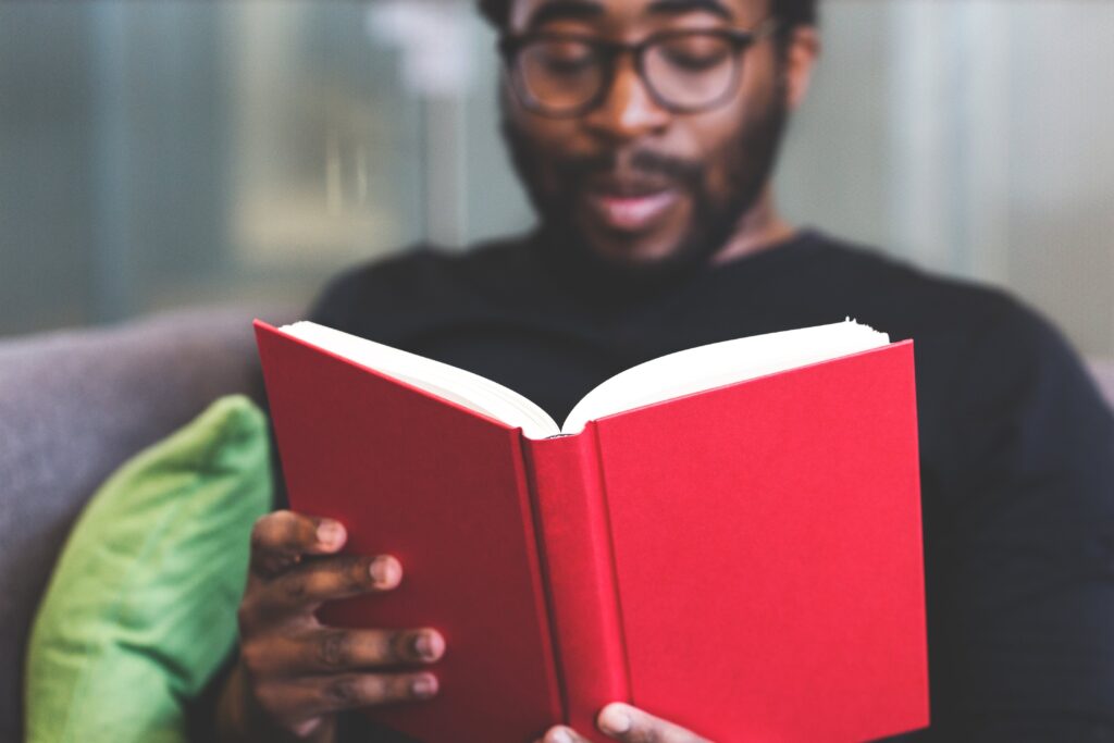Adult student reading red book