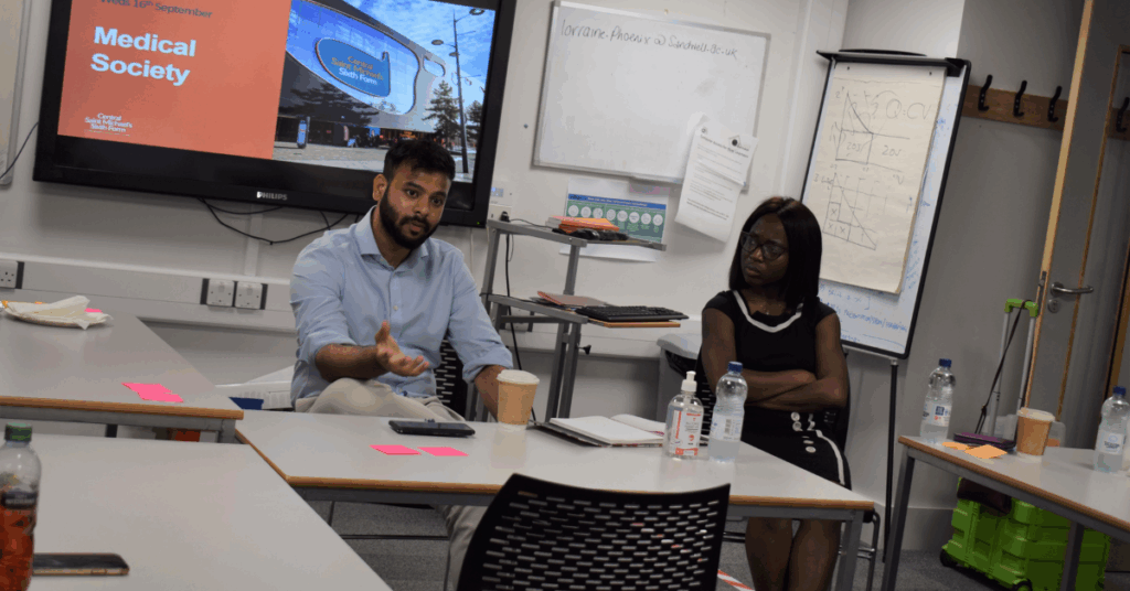 Two people discussing Medical Society