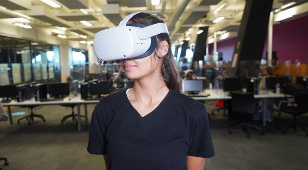 Female student wearing a virtual reality headset