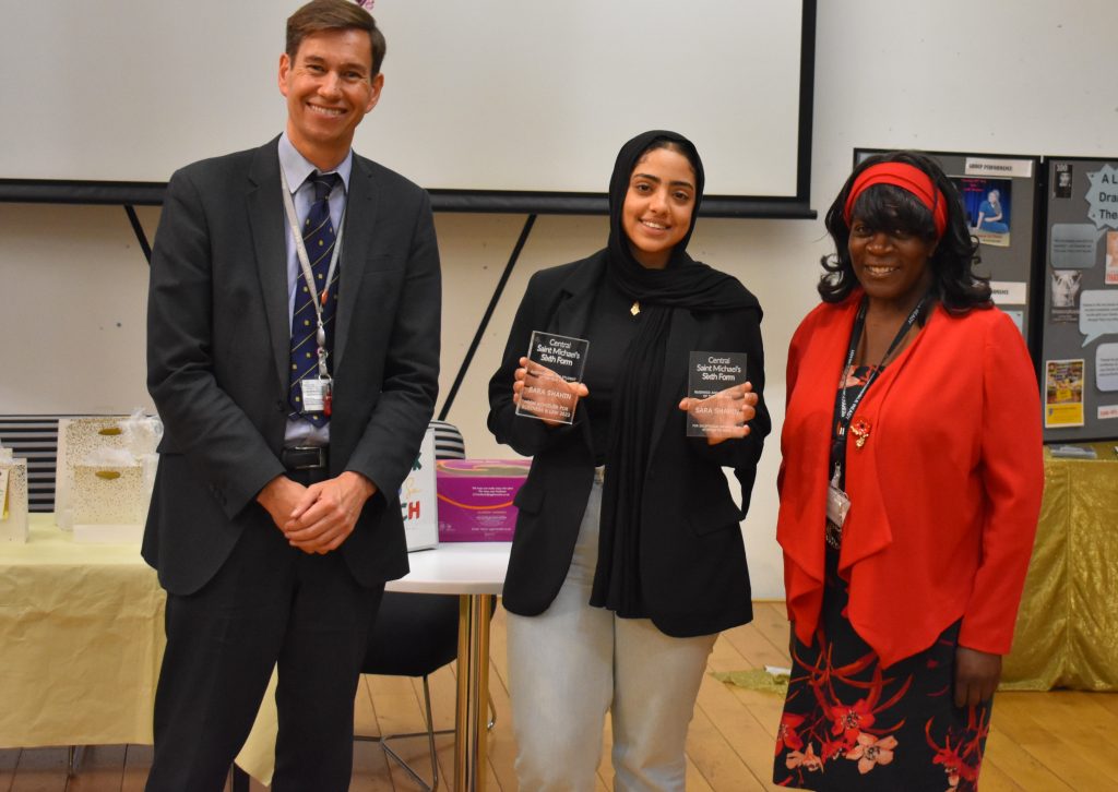 Student with two awards presented by two lecturers