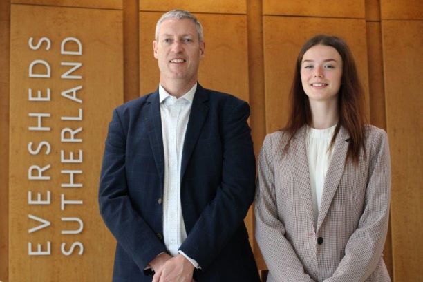 Law student with lawyer at workplace
