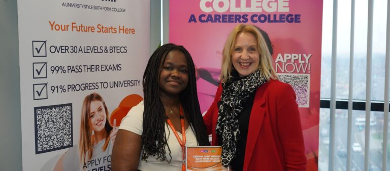 Female student presented with certificate by female MP