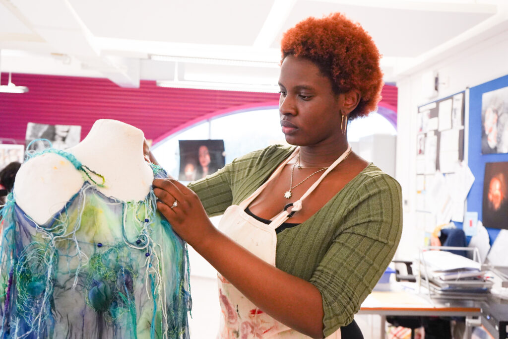 Student working on textiles project