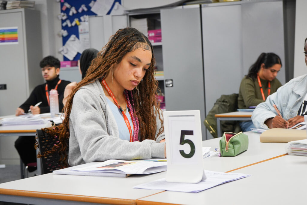 Student writing with number 5 in front