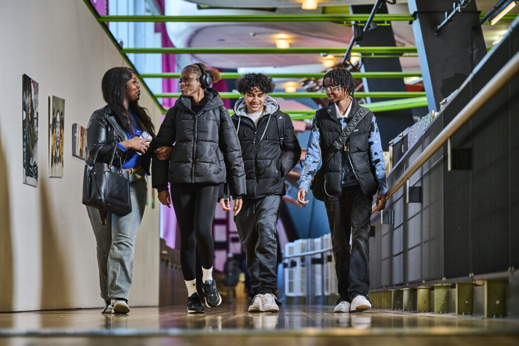 students walking up the ramp smiling