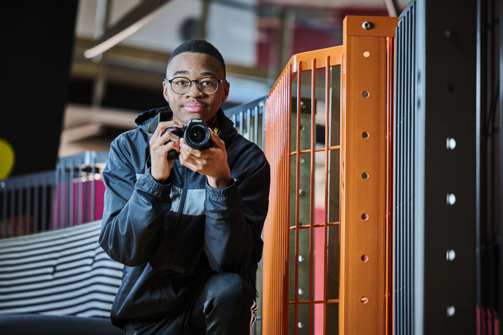 Student with a camera in corridor