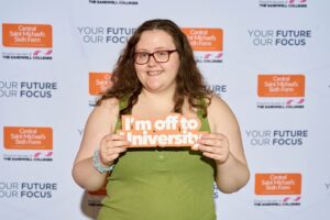 Student holding 'I'm off to University sign'