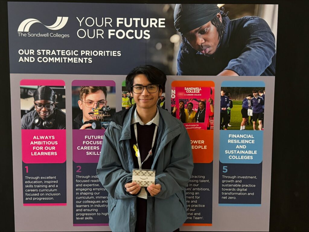 Award winning student holding voucher prize