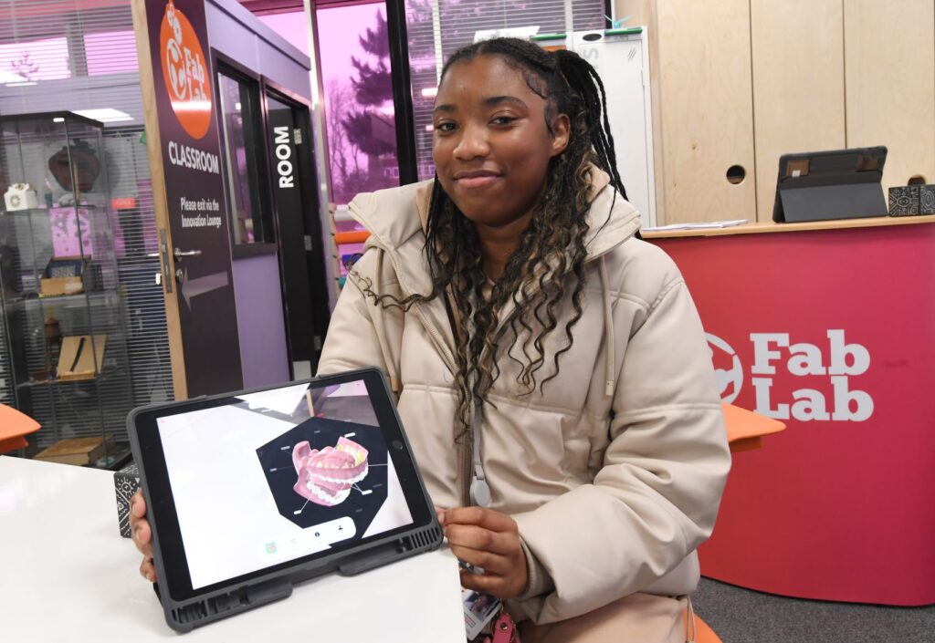 Science student showing work on tablet