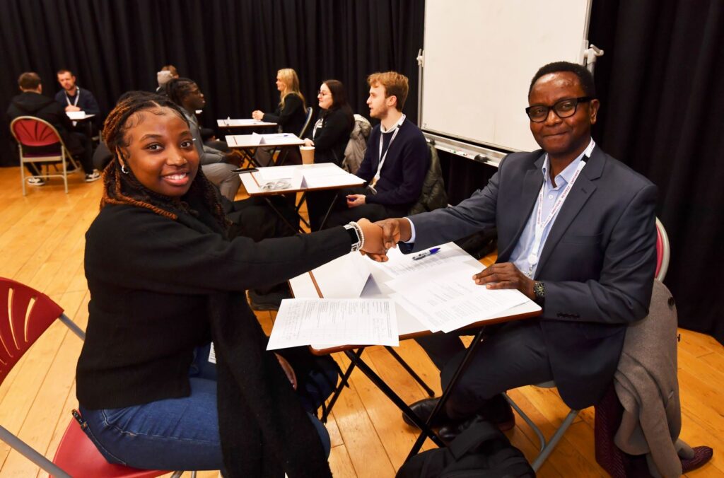 Employer shaking hands with student interviewee