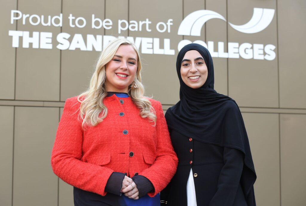 Two solicitors in front of The Sandwell Colleges sign