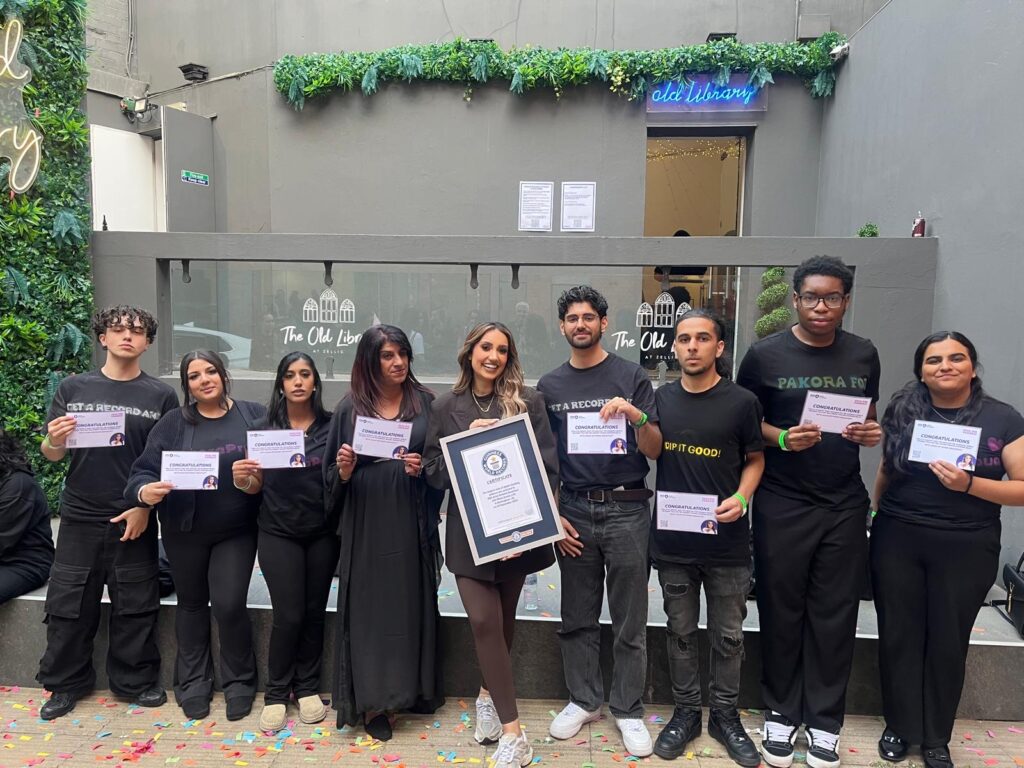 Students holding world record certificates with BBC radio presenter